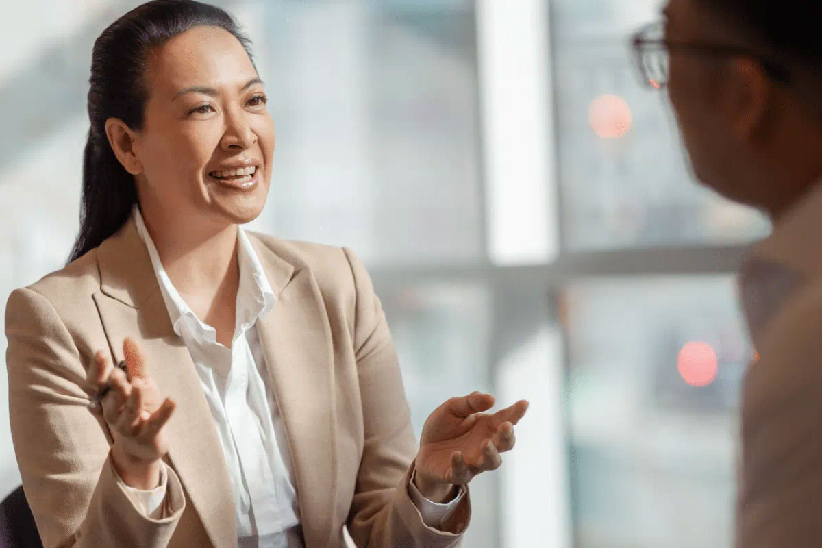 Two individuals engaged in a corporate setting, possibly a meeting.