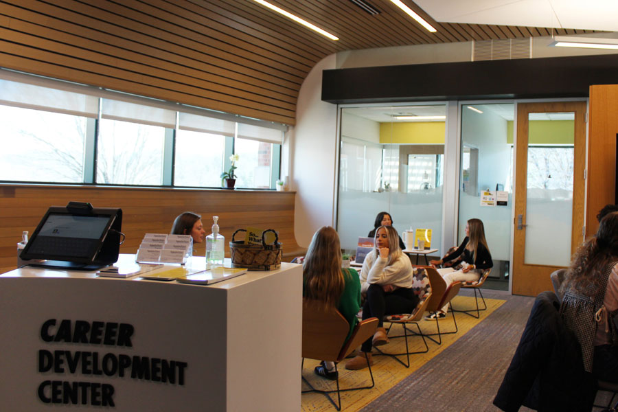 Career Development Center front desk with students seated in a waiting area.