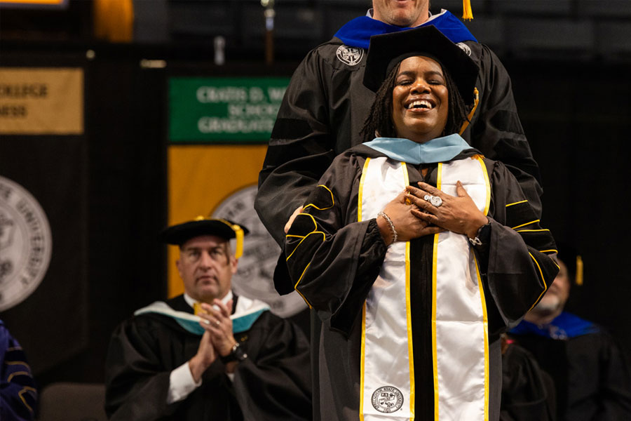 A doctoral graduate is hooded at App State’s Commencement ceremony, in Holmes Convocation Center.