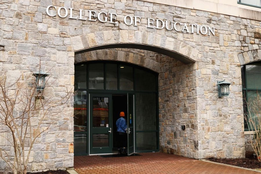 Entrance to Reich College of Education building with a person entering the door. 