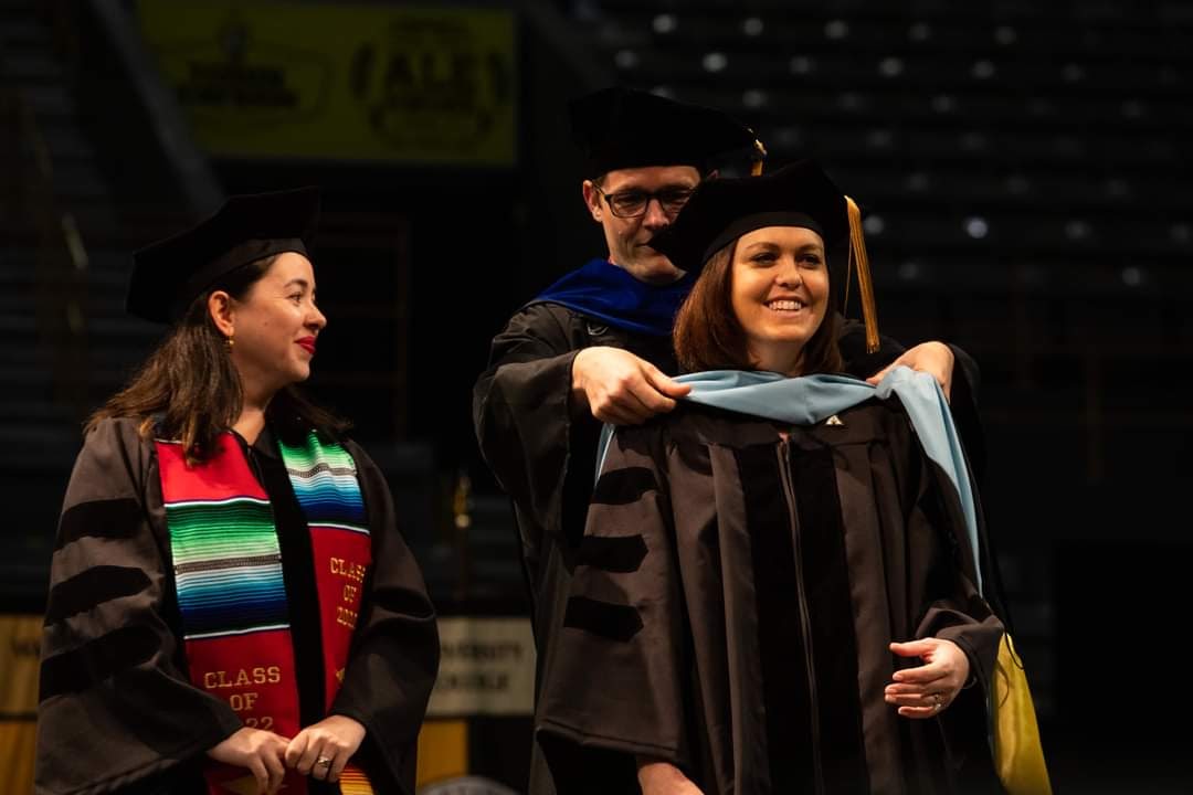 Rebecca Burry and Kimberly Nava Eggett hooded at commencement