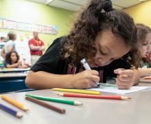 Six-year-old Keeley Neely colors at her desk inside Hardin Park Elementary in Boone, N.C., on Thursday, Oct. 10, 2024.