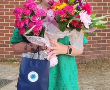 Woman celebrating with flowers.