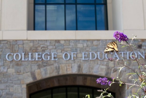 college of education building with butterfly on flower