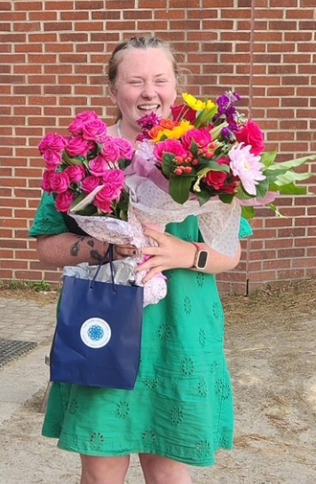 Woman celebrating with flowers.