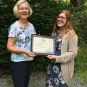Jenny Darcy accepts an award from PEO International Chapter president, Jan Noffsinger.