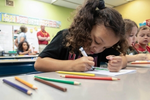 Six-year-old Keeley Neely colors at her desk inside Hardin Park Elementary in Boone, N.C., on Thursday, Oct. 10, 2024.