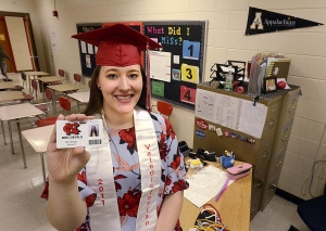 ROBERT C. REED/HICKORY DAILY RECORD: Ashley Bandy, 2011 valedictorian at Newton Conover High School, is now a mathematics teacher at her hometown high school as she holds her teacher identification card.