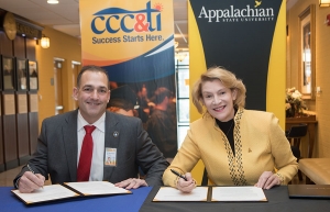 Caldwell Community College and Technical Institute President Dr. Mark Poarch, left, and Appalachian State University Chancellor Dr. Sheri Everts sign the Aspire Appalachian Co-Admission Program agreement on Wednesday, Dec. 12, in the B.B. Dougherty Administration Building on Appalachian’s campus in Boone. Photo by Marie Freeman