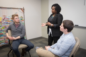 Dr. Dominique Hammonds instructs two graduate students