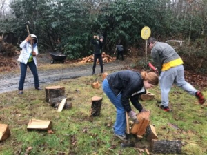 Talk about hands-on learning! AMS students teaching ASU visitors how to chop wood on a dreary Saturday.