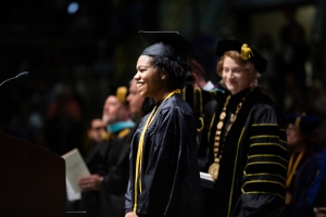 Graduating senior Maya Brown-Hughston approaches the podium as Appalachian State University Chancellor Sheri Everts looks on. Photo by Chase Reynolds