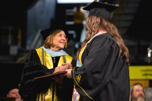 Dean Spooner congratulates graduate