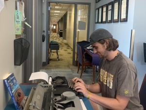 Scotty Huger, on a visit with his class, tries out a typewriter for the first time.