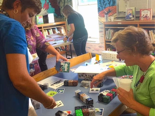 Educators working with Cubelets robotic cubes in an Instructional Materials Center.