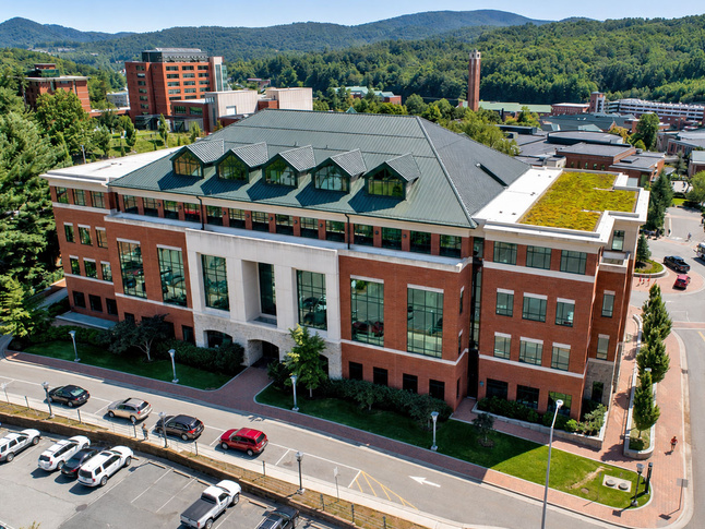 Reich College of Education with cars parked out front on a clear day.