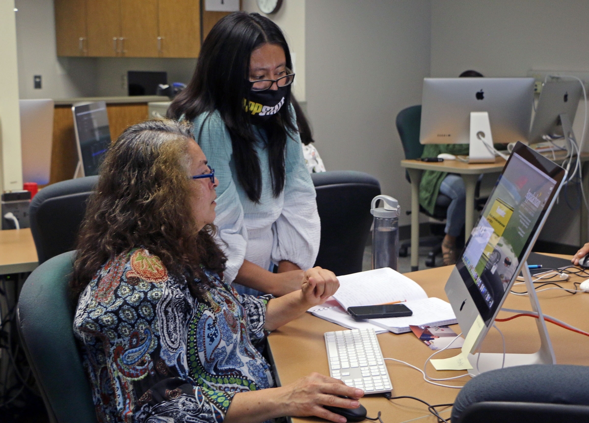 Liliana Martinez works with a student