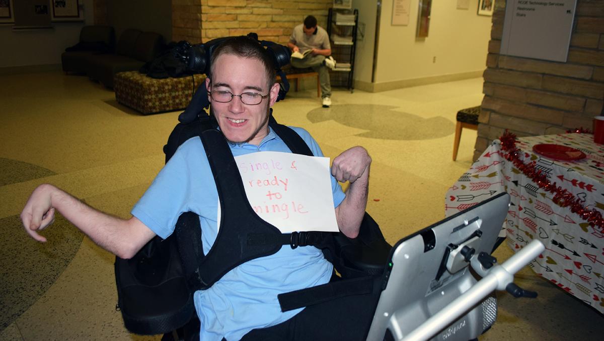 SDAP scholar Luke shows off his festive “single and ready to mingle” sign. Photo submitted