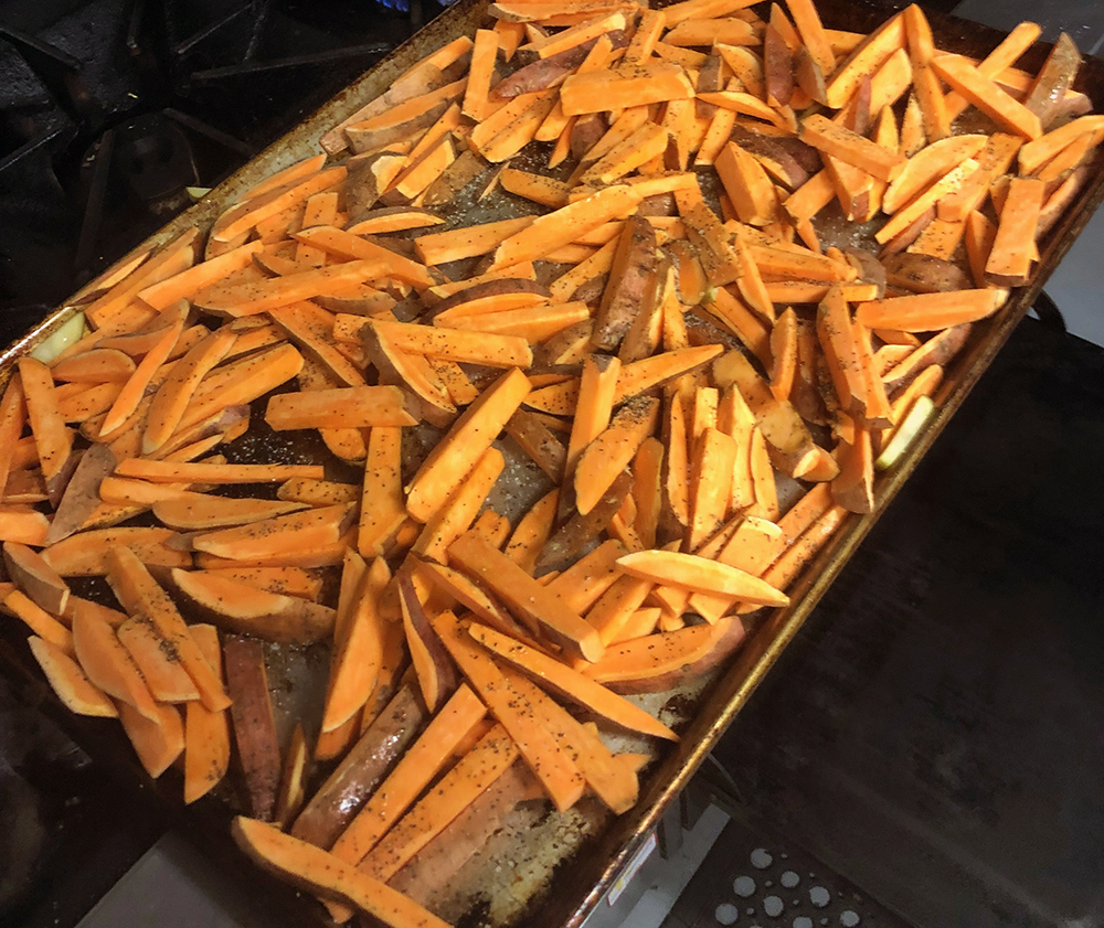 Hand-cut sweet potato fries are read to bake. Photo submittedy