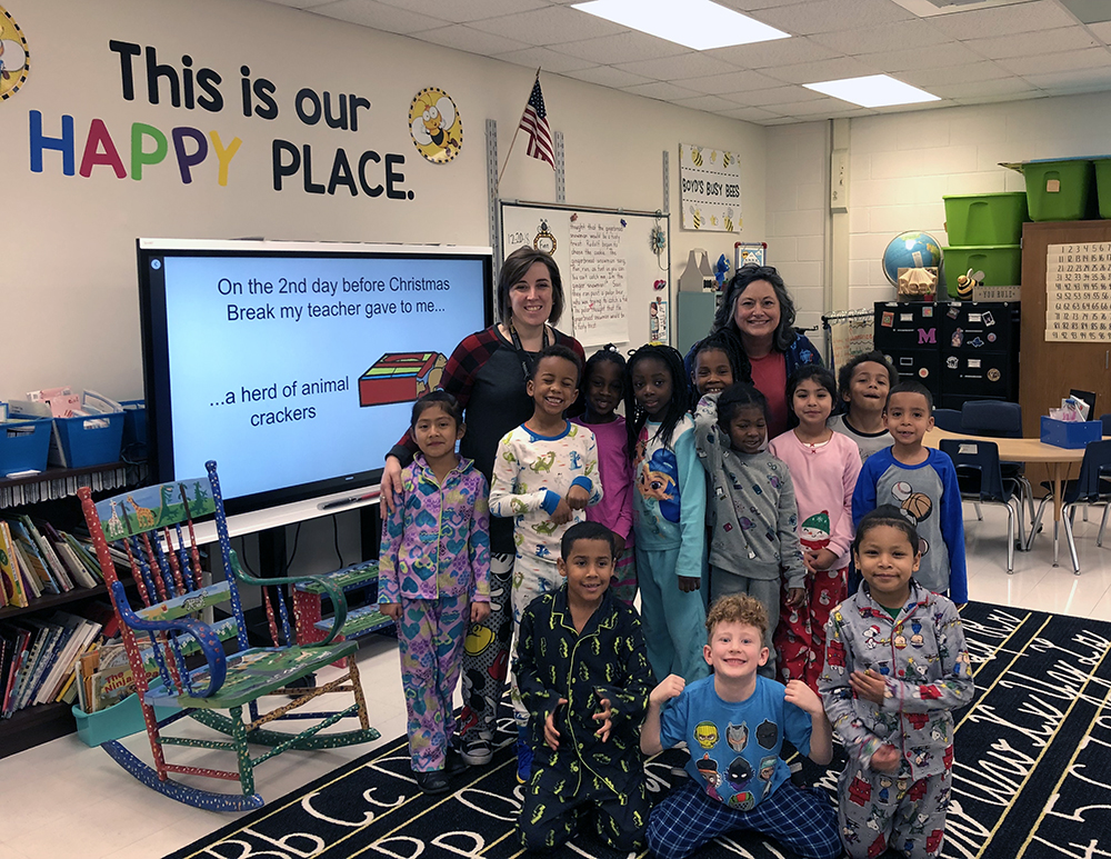 Dr. Amie Snow '01 '09, Director of Curriculum (left), 1st-grade teacher, Melissa Boyd '15 (right), and students get cozy at the Academy's PJ Day.