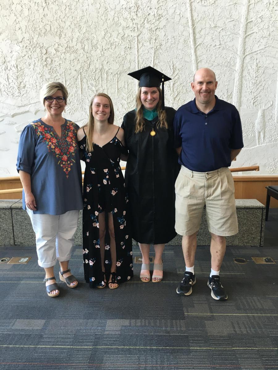 Marie (far left) with her family at her daughter’s MPA hooding ceremony.