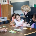 At the Appalachian State University Academy at Middle Fork, Appalachian Chancellor Sheri Everts prepares to read a story with students in the third grade classroom of teacher Heather Wham. Students photographed are: Clarise Serrano-Hernandez and Yarel Candela-Lucero. Photo by Marie Freeman