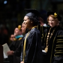 Graduating senior Maya Brown-Hughston approaches the podium as Appalachian State University Chancellor Sheri Everts looks on. Photo by Chase Reynolds