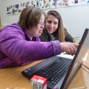Graduate assistant Miriam Stapp, right, and Victoria Hall work on her writing assignment together.