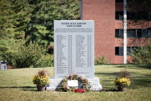 The new historic marker, with university buildings in the background.