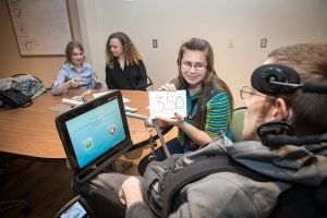 Pictured from left to right, SDAP student Reid Pond, from Boone, Mary Strong ’16 ’17, transition and career coordinator for SDAP, and SDAP students Elizabeth Droessler, from Wake Forest, and Luke Wilcox, from Boone, practice counting money as part of the training at ECRS. Photo by Marie Freeman